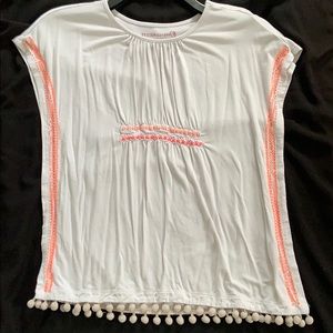 A white blouse with tassel cover-up shirt